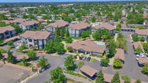 Aerial Exterior of Norden Terrace, parking lot, residential buildings, photo taken on a sunny day.
